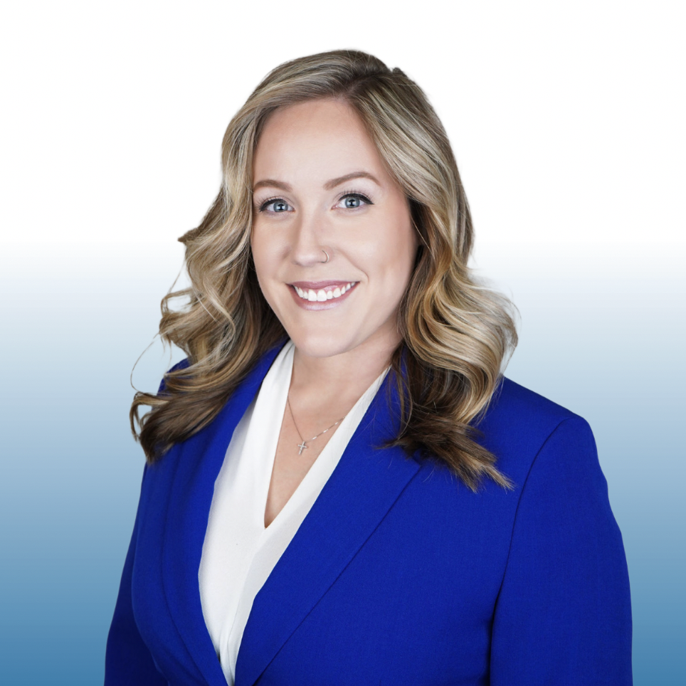 Professional headshot of an Equity commercial real estate team member in a royal blue blazer